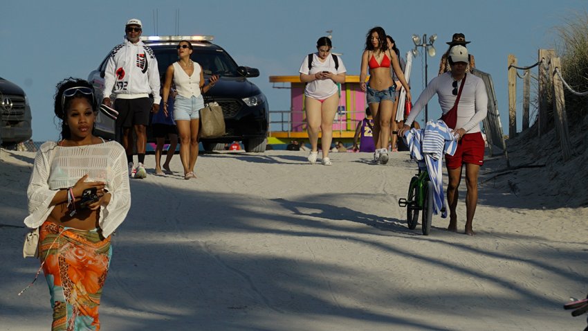 MIAMI, UNITED STATES – MARCH 13: People walk off Miami Beach after its closure as part of measures to control spring break, in Miami, United States March 13, 2025. (Photo by Jesus Olarte/Anadolu via Getty Images)