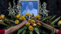 YOGYAKARTA, INDONESIA – APRIL 22: An image of Pope Francis is displayed on the altar as faithfuls arrange flowers at the St. Maria Assumpta Catholic Church on April 22, 2025 in Yogyakarta, Indonesia. Pope Francis, the first Latin American and Jesuit pope, died on Easter Monday at the age of 88 at the Vatican’s Casa Santa Marta after battling pneumonia and other health issues. His death marks the end of a 12-year papacy characterized by efforts to reform the Church, advocate for the marginalized, and promote inclusivity, and it initiates the traditional process of selecting a new pope. (Photo by Ulet Ifansasti/Getty Images)