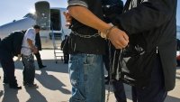 Undocumented immigrants, shackled at the wrists and ankles, were searched before boarding a charter flight at Kansas City International Airport, run by the Immigration and Customs Enforcement (ICE) Department. The detainees were flown to Louisiana, Texas or Arizona, where they are returned to or flown to the detainees countries of origin.