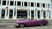 uristas pasean en un auto clásico este viernes, en una calle de La Habana (Cuba). EFE/ Ernesto Mastrascusa