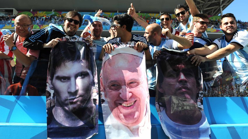 SAO PAULO, BRAZIL – JULY 01: Argentina fans display posters of Lionel Messi, Pope Francis and Diego Maradona during the 2014 FIFA World Cup Brazil Round of 16 match between Argentina and Switzerland at Arena de Sao Paulo on July 01, 2014 in Sao Paulo, Brazil. (Photo by Chris Brunskill Ltd/Getty Images)