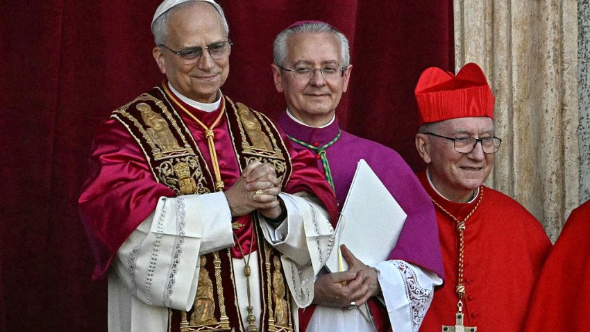 Newly elected Pope Leo XIV, Robert Prevost (L) gestures as he arrives on the main central loggia balcony of the St Peter’s Basilica for the first time, after the cardinals ended the conclave, in The Vatican, on May 8, 2025. Robert Francis Prevost was on Thursday elected the first pope from the United States, the Vatican announced. A moderate who was close to Pope Francis and spent years as a missionary in Peru, he becomes the Catholic Church’s 267th pontiff, taking the papal name Leo XIV. (Photo by Gabriel BOUYS / AFP) (Photo by GABRIEL BOUYS/AFP via Getty Images)