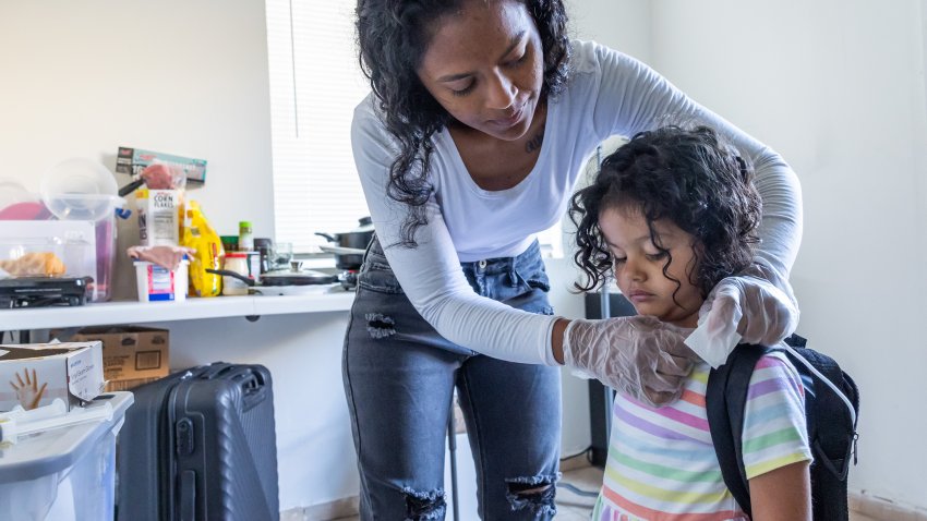 As part of her daily routine, Deysi Vargas runs a saline solution through her daughter's intravenous line before her morning shower and school.