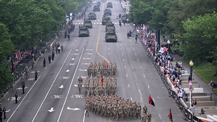 Armored vehicles and infantry soldiers march during the Army 250th Anniversary Parade in Washington, DC, on June 14, 2025. US President Donald Trump reveled in a long dreamt-of military parade on his 79th birthday Saturday, as demonstrators across the country branded him a dictator in the biggest protests since his return to power. (Photo by Alex WROBLEWSKI / AFP) (Photo by ALEX WROBLEWSKI/AFP via Getty Images)