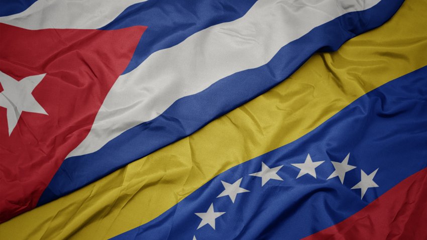 waving colorful flag of venezuela and national flag of cuba. macro