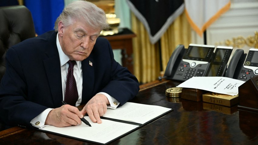 US President Donald Trump signs an executive order cracking down on mail-in voting ahead of midterm elections in the Oval Office of the White House in Washington, DC, on March 31, 2026. President Donald Trump on March 31 signed an order seeking to crack down on mail-in voting, escalating his push to restrict a popular way of casting ballots in US elections. Trump’s executive order follows repeated attacks by the 79-year-old Republican on US elections, based on his disproven conspiracy theories about supposed cheating by his Democratic opponents. It was unclear whether Trump has authority to impose the measures and legal challenges were almost certain, with a possible final decision being left to the Supreme Court. (Photo by Brendan SMIALOWSKI / AFP via Getty Images)
