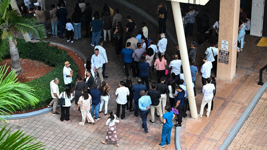 People wait in line outside the Miami Immigration Court in Miami, Florida, on September 3, 2026. Long lines have become the new norm at the court following the implementation of the Trump administration’s "mega master" calendar hearings, which bring large numbers of immigration cases before judges at the same time. The Miami Immigration Court falls under the jurisdiction of the Office of the Chief Immigration Judge, which is a component of the Executive Office for Immigration Review under the Department of Justice. (Photo by CHANDAN KHANNA / AFP via Getty Images)